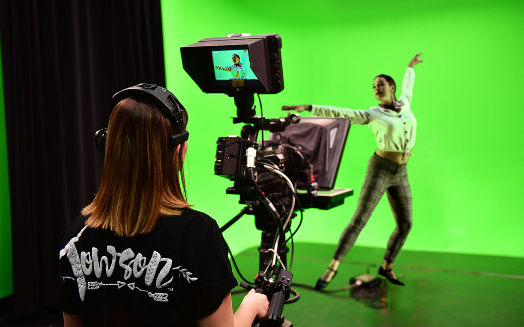 Student filming dancer with green screen