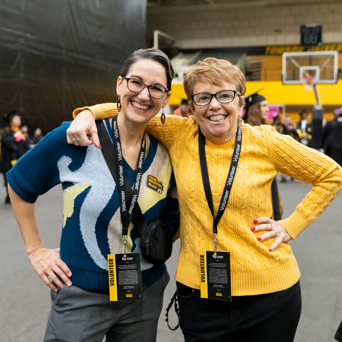 Rebecca Walsh smiling with fellow staff member