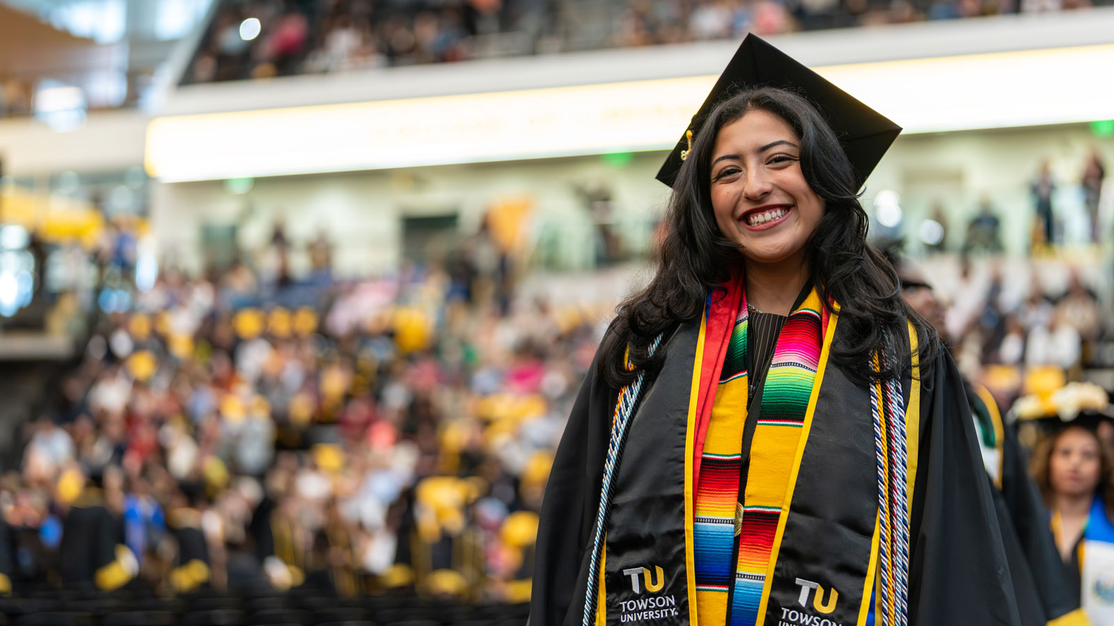 Stephanie Duque processes down the aisle at her commencement ceremony