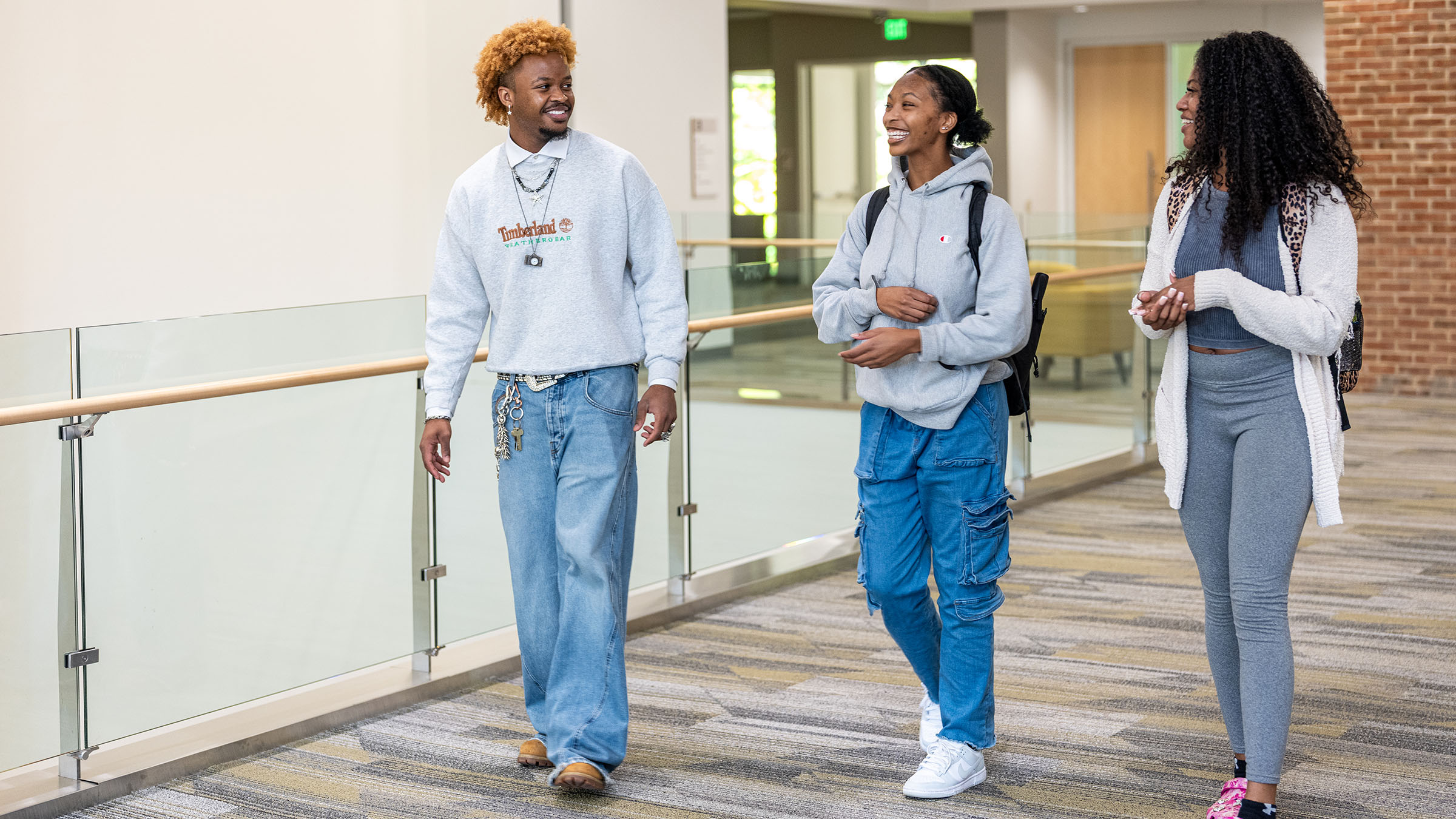 Towson University students walk and chat on campus. 