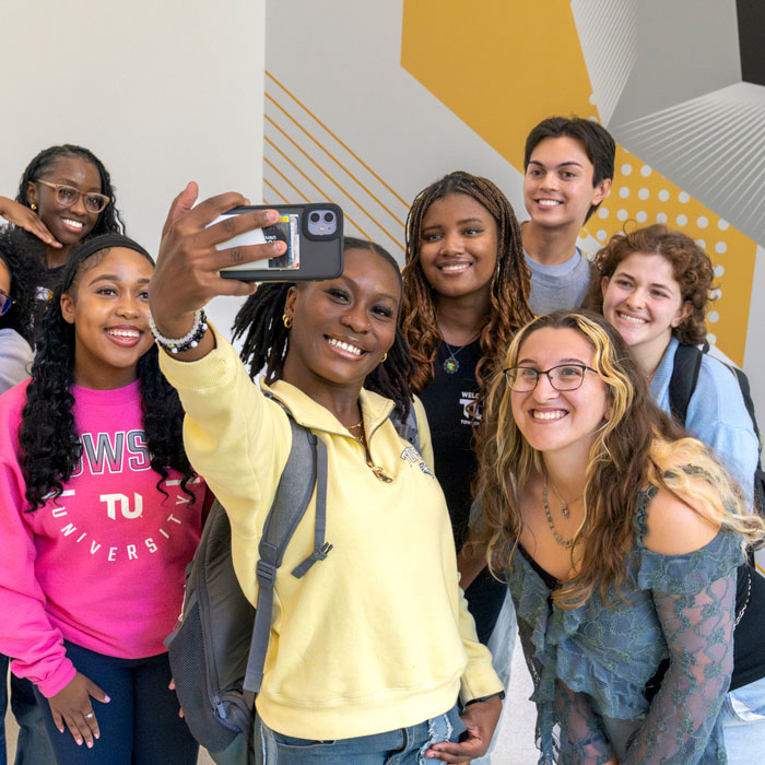 Students taking a selfie in the Union stairwell