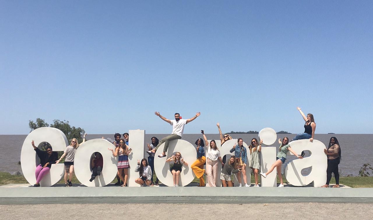 TU students sit around "Colonia" sculpture