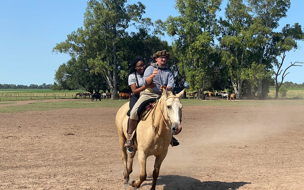 Ayomide Fashola rides a horse with a "gaucho" on a ranch in Buenos Aires