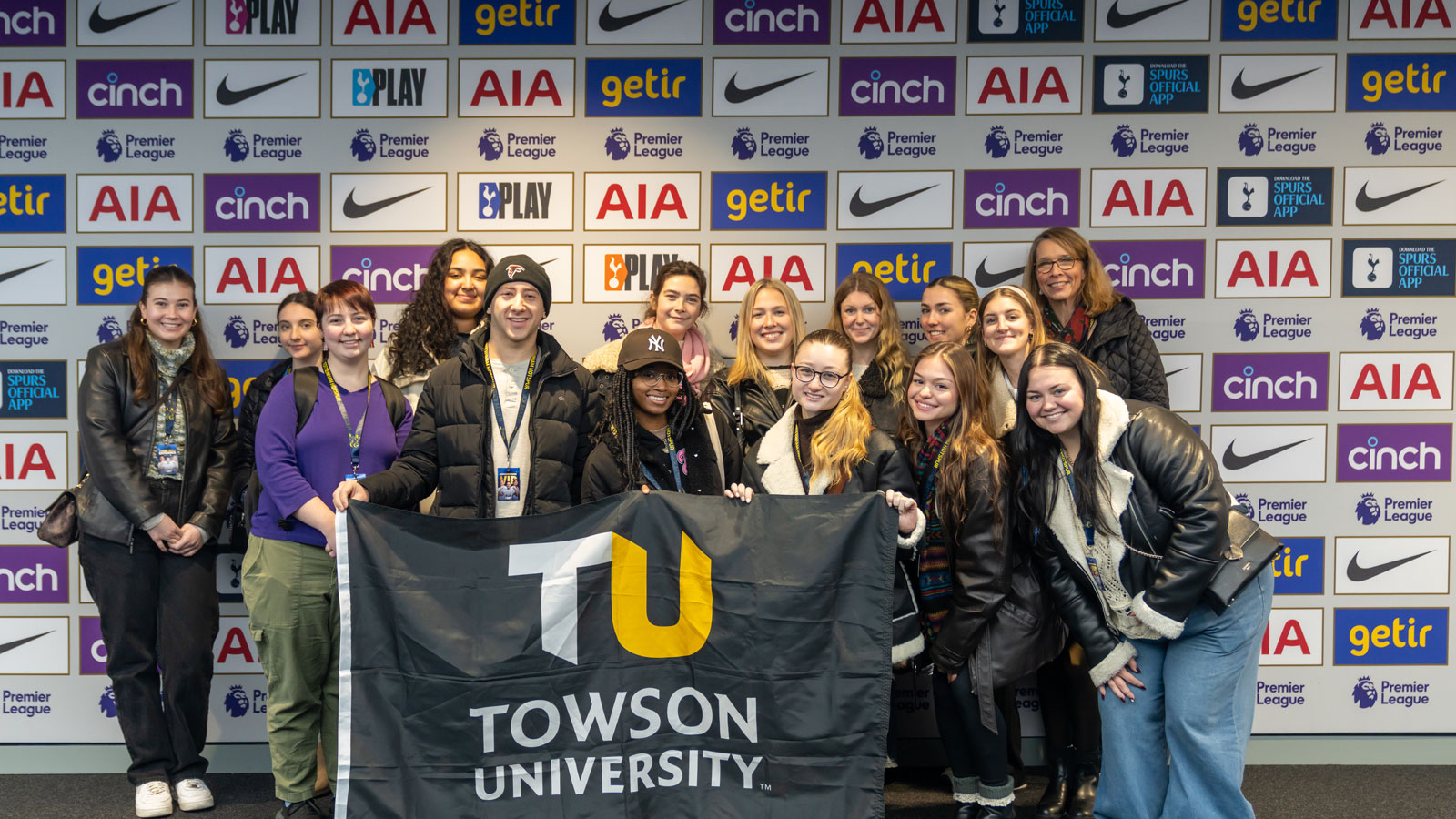 Group of TU students hold a TU flag while in London on a study abroad program