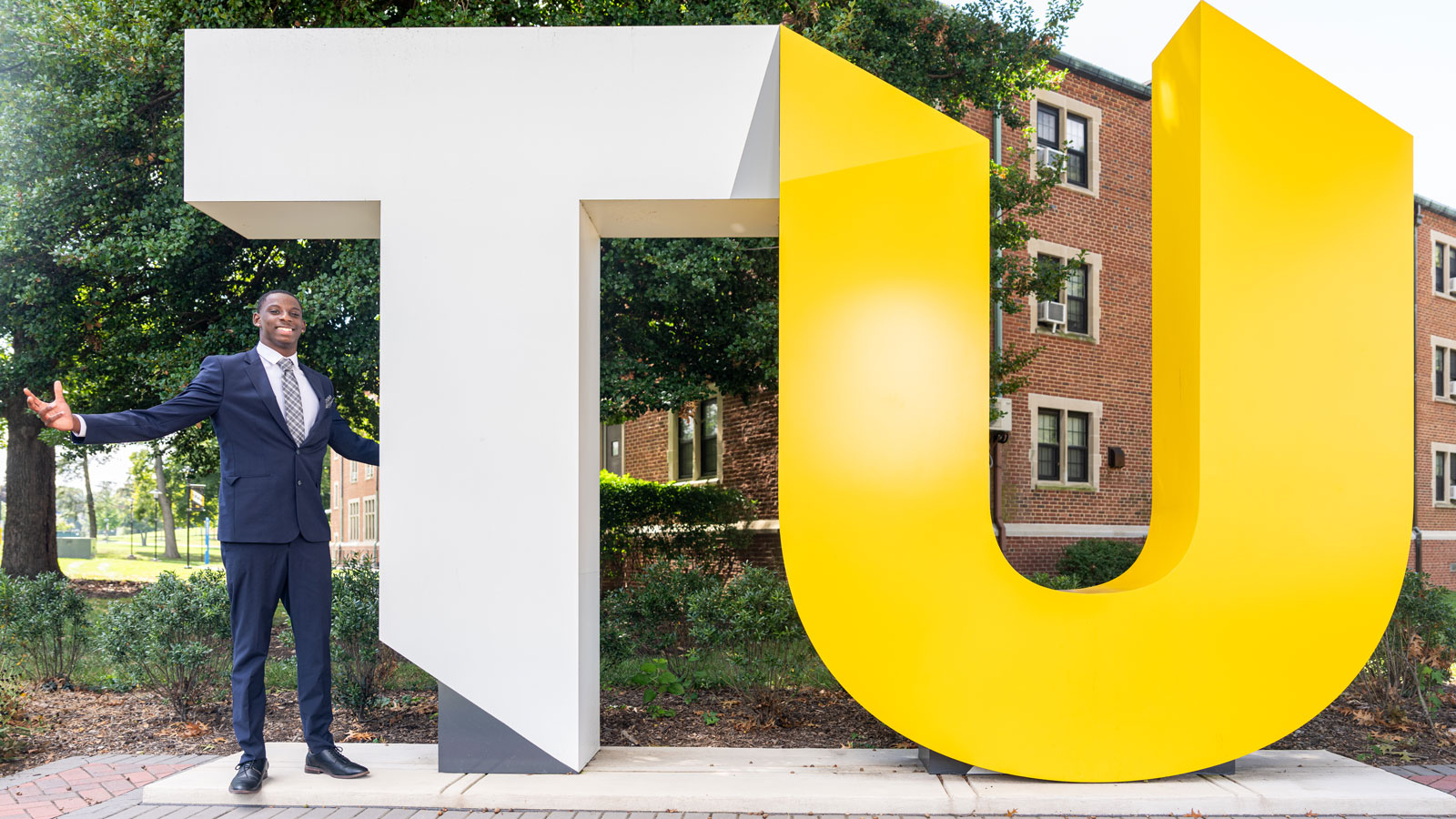 Junior Tali Simpkins posing at the TU Sign on Cross Campus 