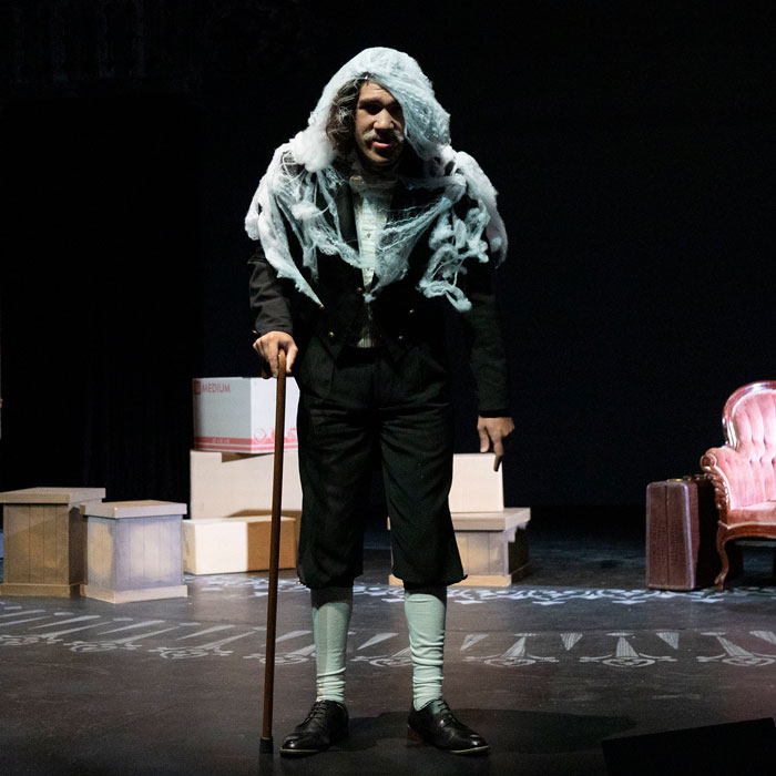 A student in a scene in a production TU's Cherry Orchard