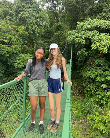 Brianna and Caroline stand together on floating bridge in Costa Rica.