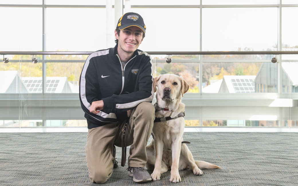 Tim Utzig '20 with his service dog Alisa