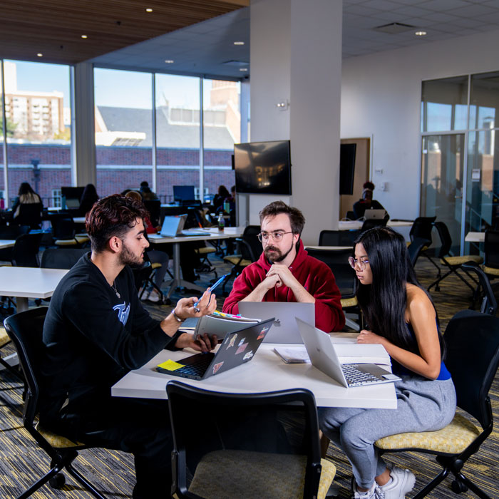 Students sit and study together in the Academic Commons