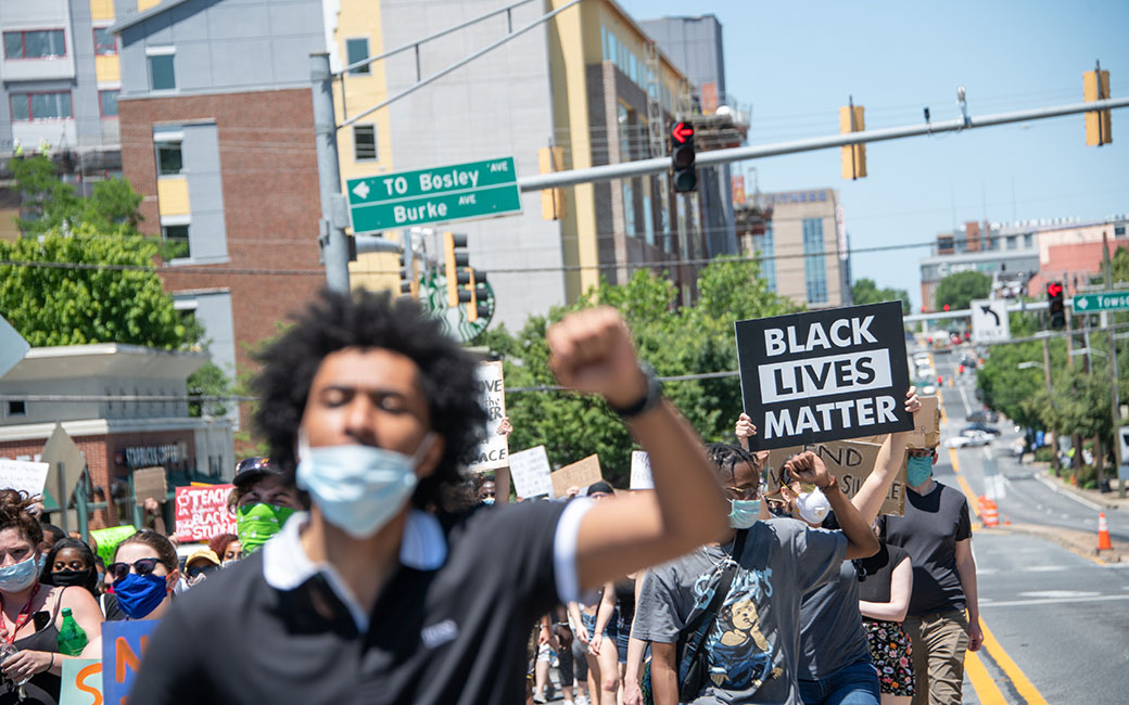 Black Lives Matter marchers on street holding signs