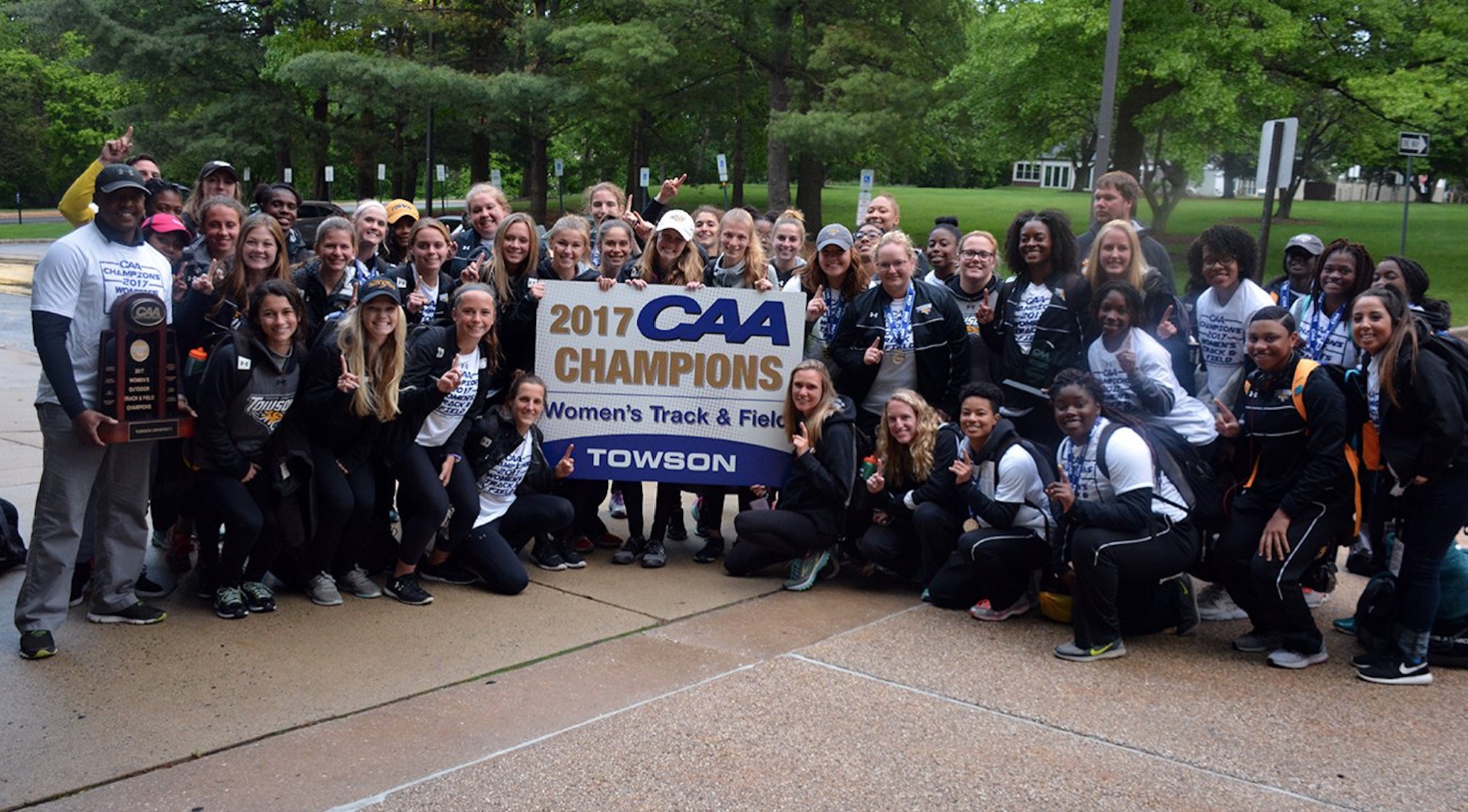 The Towson women's track and field team poses with the trophy after the team captured its first Colonial Athletic Association (CAA) Outdoor Track & Field Championship on Saturday afternoon.
