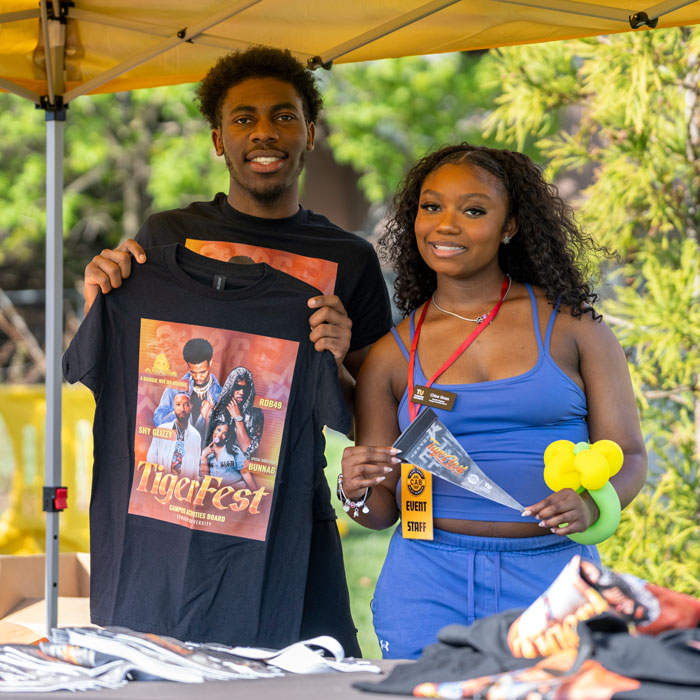 Two students hold up the 2026 CAB-made Tigerfest t-shirt giveaway