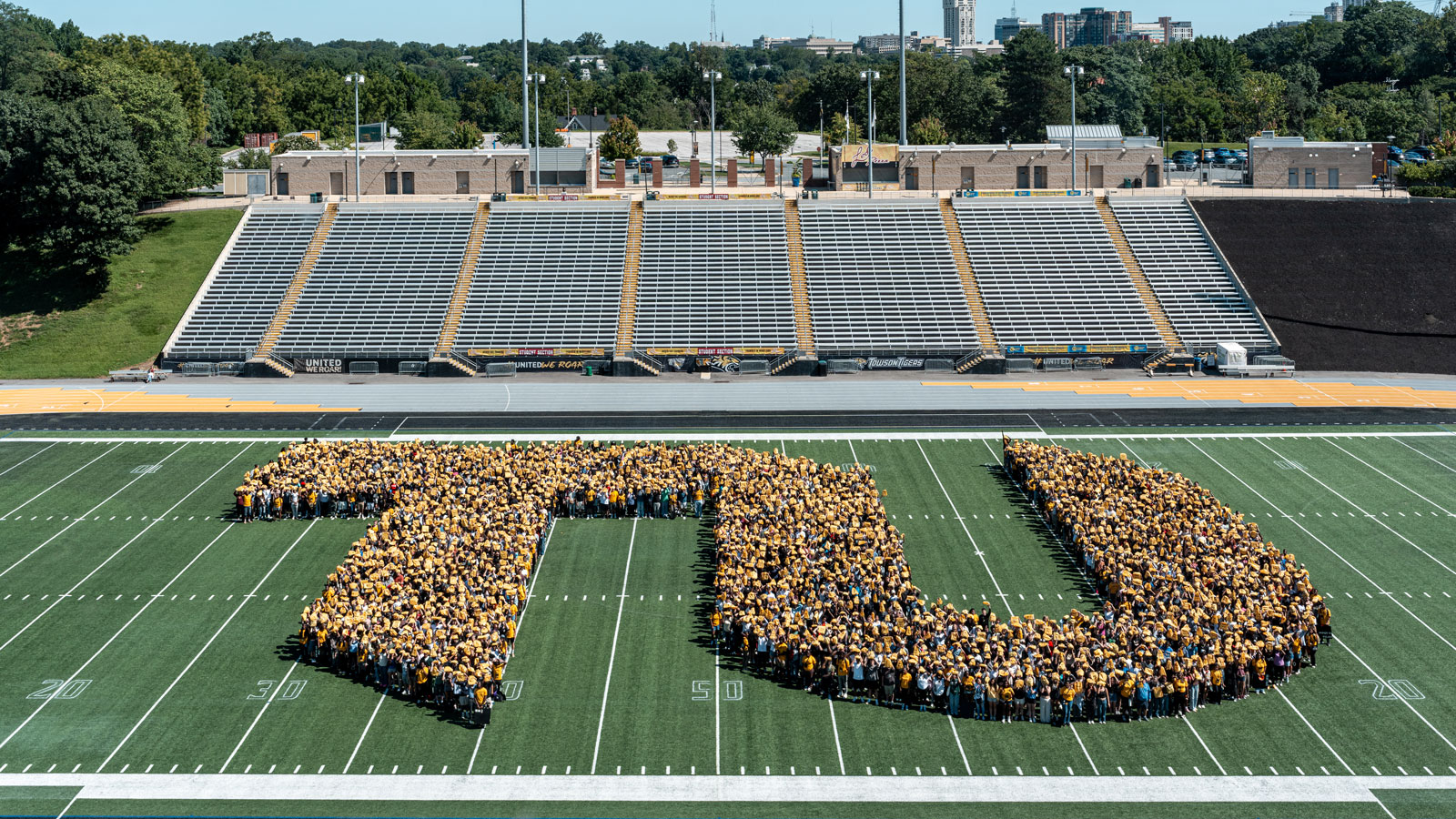 New students pose in the Towson University branded TU at Unitas Stadium 