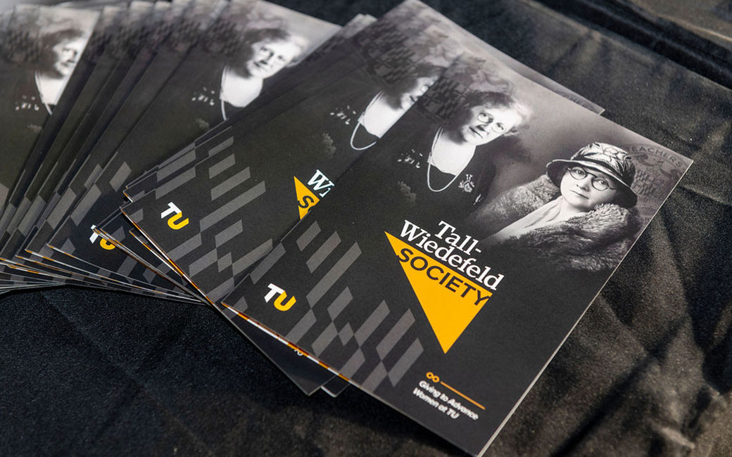 Tall-Wiedefeld Society brochures in a stack