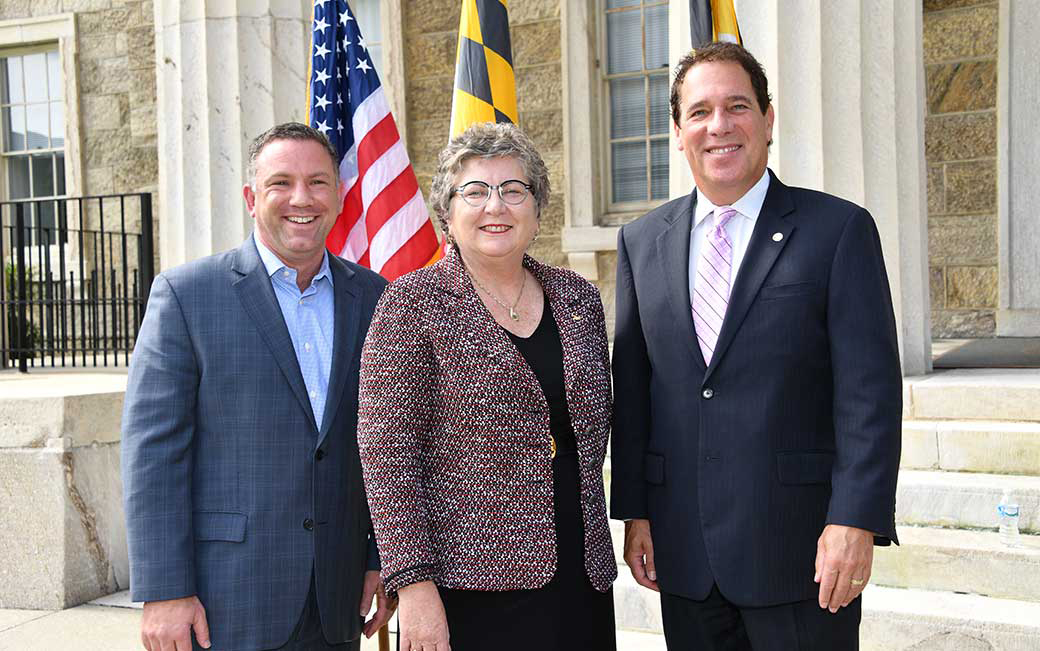 Towson University President Kim Schatzel poses with Baltimore County Executive Kevin Kamenetz (right) and Ken Ulman (left)