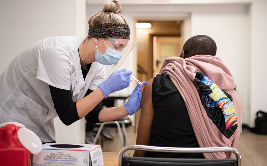 A nursing student administers a vaccine