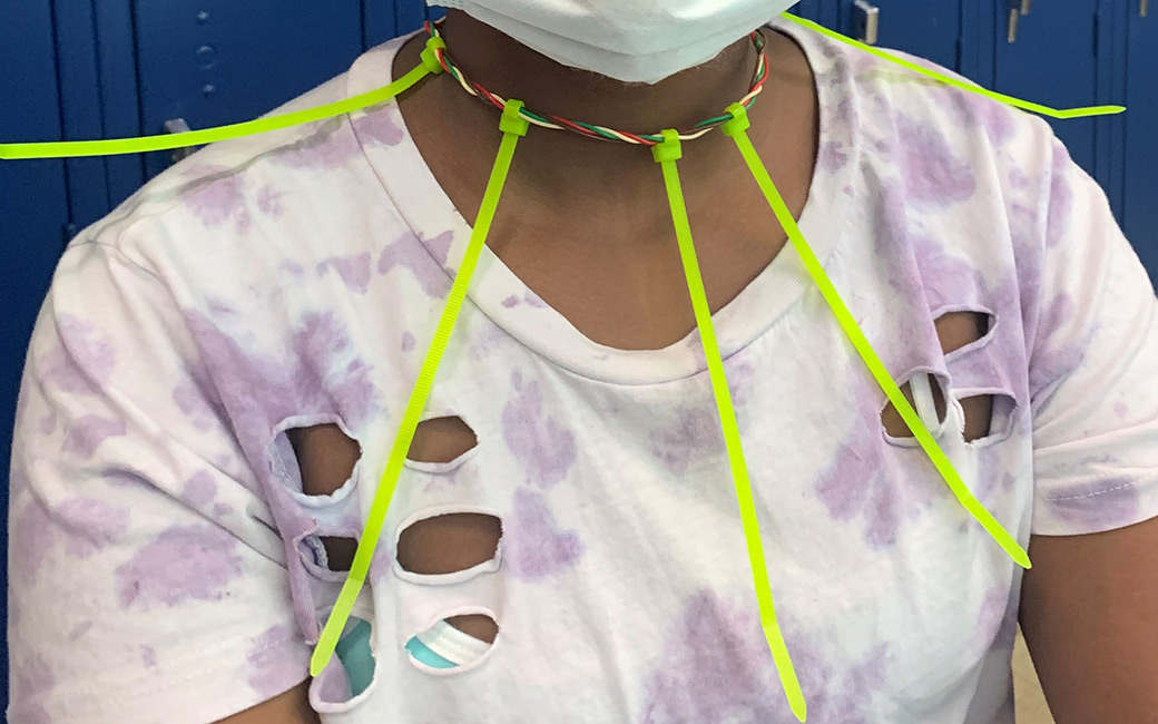 Neck and shoulders of student wearing creation made of wire and zip ties