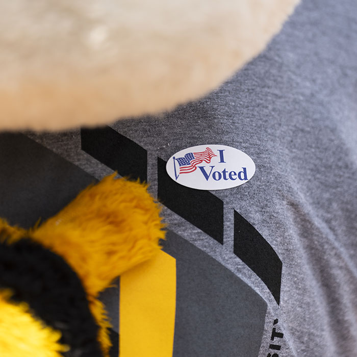 Towson University Mascot Doc pointing to a voting sticker