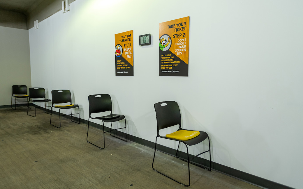 Chairs spaced against wall with signs