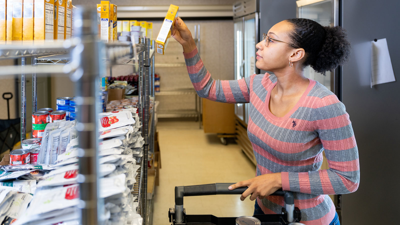 A student picks up food from the Towson University FoodShare located at the Basic Needs Hub