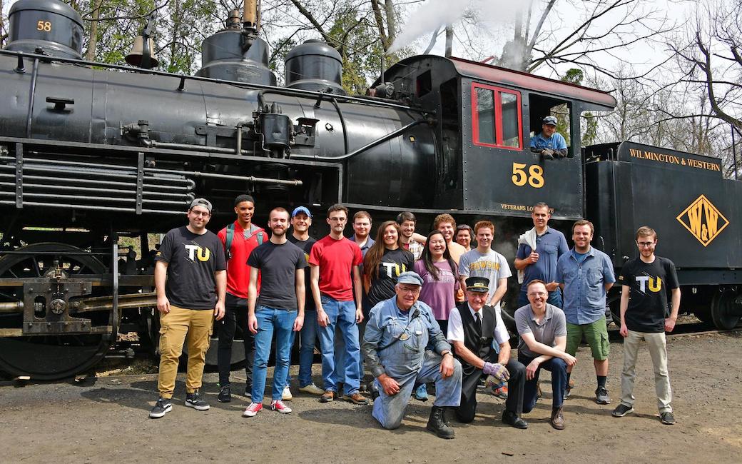 Group photo in front of train