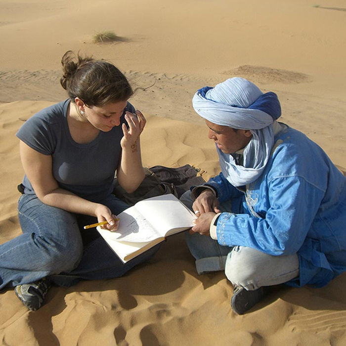 student and professor in the desert