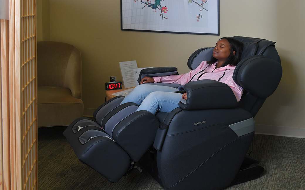 student in a massage chair