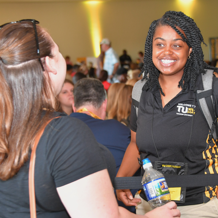 Smiling OL talking to another student