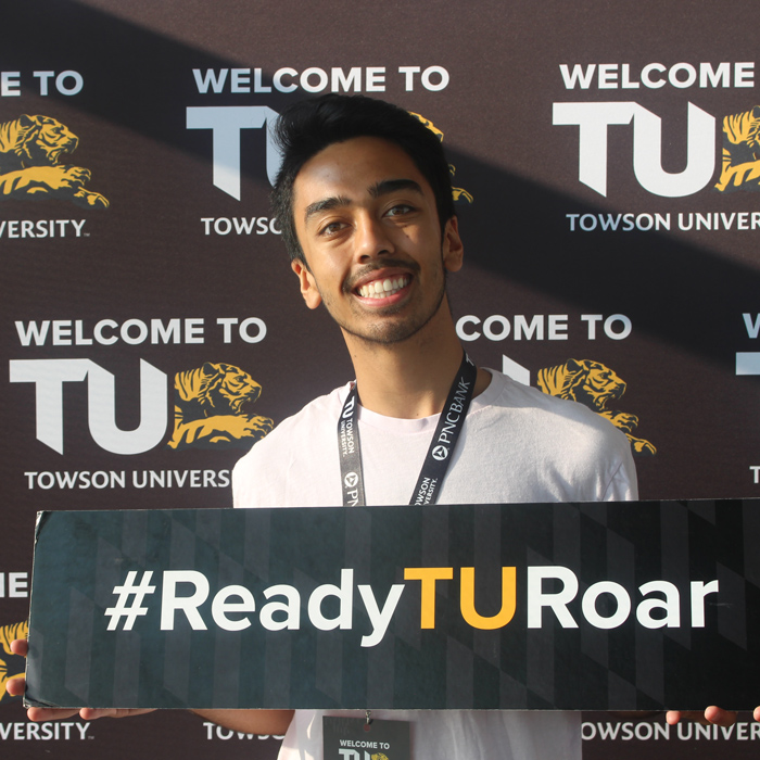 Student holding Ready to Roar sign