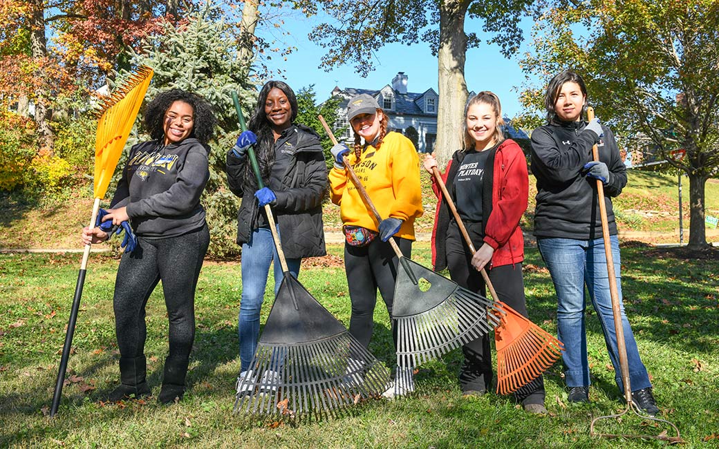 Student remove leaves in a local park.  