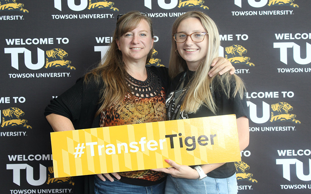 mom and student smiling at the camera holding a sign that says transfer tiger