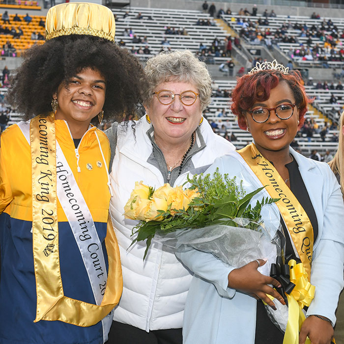 TU President with two members of the Homecoming Court
