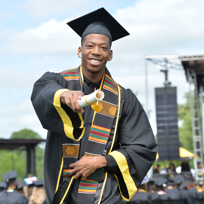 Student with diploma at graduation